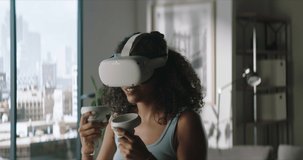 Portrait of excited African American female taking off her VR virtual reality metaverse headset at home after finishing playing