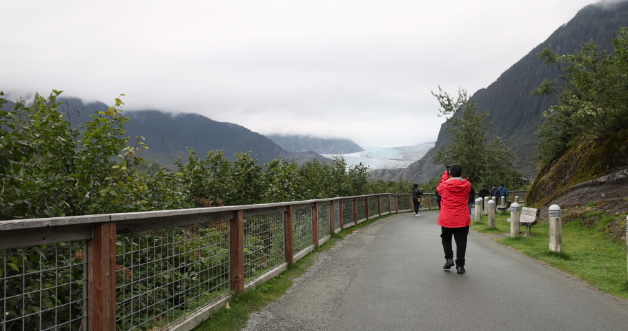 Mendenhall Glacier tourist walking trail. Cruise ship destination near Juneau Alaska. Climate change global warming result is rapidly retreating, shrinking, and melting. Scientific study. Royalty-Free Stock Footage #1094319111