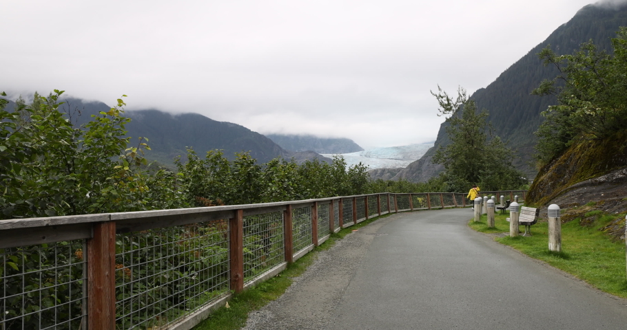 Mendenhall Glacier Alaska walking trail. Cruise ship destination near Juneau Alaska. Climate change global warming result is rapidly retreating, shrinking, and melting. Scientific study. Royalty-Free Stock Footage #1094319141