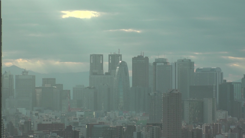 TOKYO, JAPAN : Aerial high angle sunset CITYSCAPE of TOKYO. View of office buildings at downtown area around Shinjuku. Long time lapse shot, dusk to night. Japanese urban metropolis concept video.
