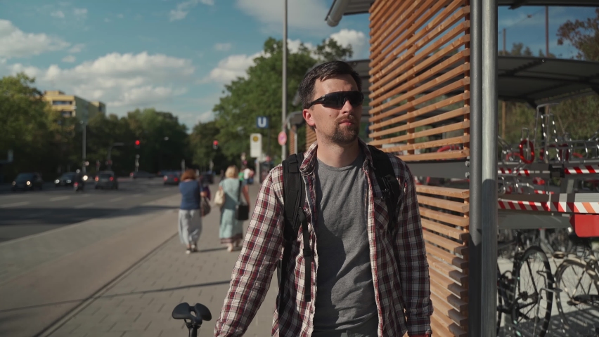 Man parks his bicycle in two-level bicycle parking lot in Munich, Germany. Double decker bicycle parking lot. Bicyclist parking his cycle in a split level bicycle parking lot. Cycling infrastructure