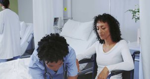Animation of spots over african american female nurse with patient. International day of persons with disabilities concept digitally generated video.