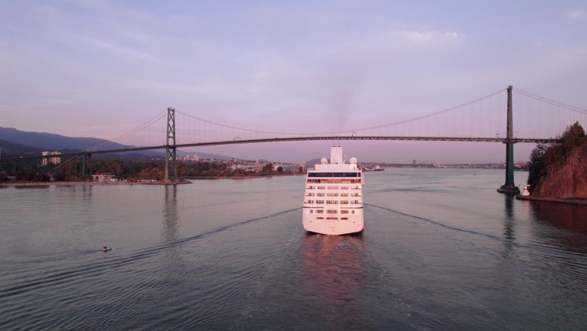 Cruise ship sailing out of Vancouver harbour at sunset, cruise line, large boat, luxury cruise, aerial footage. 4K 4096x2304 24FPS.