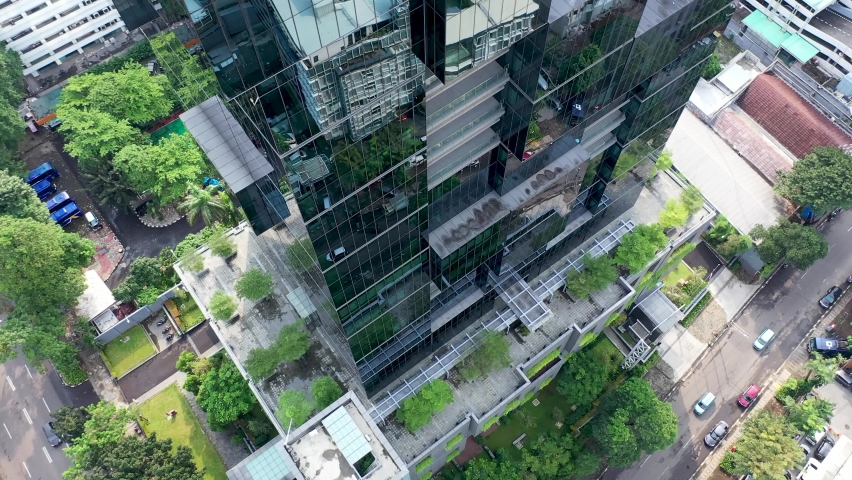 Skyscrapers with flowers and vegetation along balconies in city Jakarta