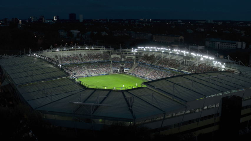Aerial Establishing Shot of a Whole Stadium with Soccer Championship Match. Teams Play, Crowds of Fans Cheer. Football Tournament, Cup Broadcast. Sport Channel Television Playback, Screen Content Royalty-Free Stock Footage #1094343481