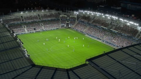 Aerial Establishing Shot of a Whole Stadium with Soccer Championship Match. Teams Play, Crowds of Fans Cheer. Football Tournament, Cup Broadcast. Sport Channel Television Playback, Screen Content – Stockvideo