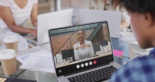 African american man using laptop for video call, with business colleague on screen. Business communication technology and remote home working, digital composite video.