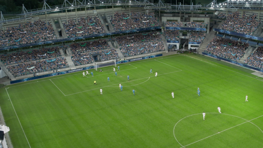 Soccer Football Championship Stadium with Crowd of Fans: Blue Team Attack and Score Goal, Players Celebrate Victory, Win the Tournament. Sport Channel Broadcast Television Playback. Moving Aerial Shot