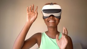 Amazed Black woman testing wearing virtual reality simulator headset home. Happy smiling wow positive emotions. Video footage. 