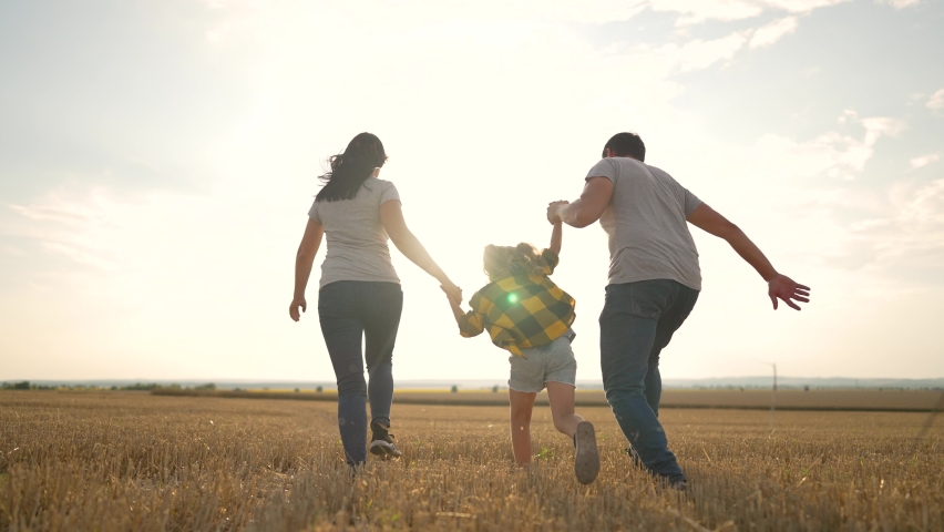 Happy family. Farmer family in the wheat field. Family picnic in nature. Farmer's family harvesting wheat. People run across the field holding hands. People game and running across field in nature. Royalty-Free Stock Footage #1094350293