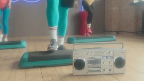 Low section of cropped man bringing tape recorder to fitness studio at daytime, starting group step aerobics class - Powered by Shutterstock - Get 15% off with code: PIKWIZARD15