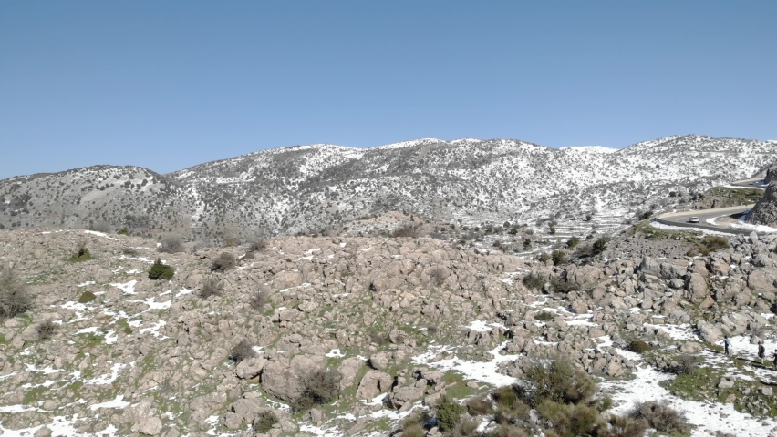 Oak Forest and mounatin with snow, aerial

Snow covered limestone mountain foothills, drone view,Hermon, israel 2021
