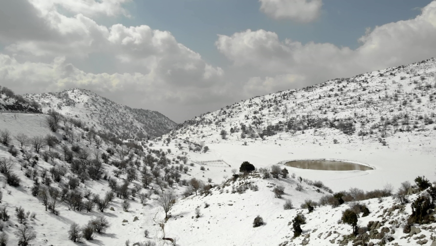 Oak Forest and mounatin with snow, aerial, 2021

Snow covered limestone mountain foothills, drone view,Hermon, israel 2021
