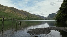 Aerial footage of the Lake District in Cumbria. Views of Buttermere Lake in the North West England. With sunlit mountains
