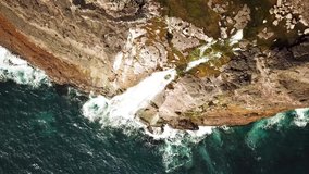 Aerial view of Bosdalafossur waterfall near Slave cliff or Traelanipan and Sorvagsvatn lake or Leitisvatn in Faroe Islands. Amazing nature. Huge cliffs. Lake above the ocean. 4k footage.