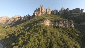 Fast extreme close dive, drop down, steep rocky mountains, cliff top slopes and scenic rock canyon on sunny day, racing drone, first point of bird's eye view. Mountains of Spain