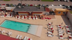 Aerial Pan Over Retro Route 66 Motel Pool Club With Sunbather - Powered by Shutterstock - Get 15% off with code: PIKWIZARD15