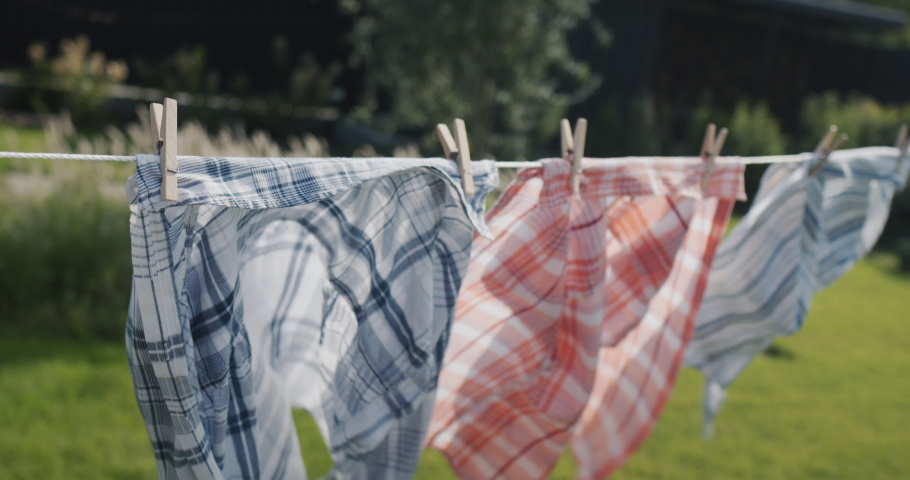 Wet shirts to dry on a clothesline in the wind Royalty-Free Stock Footage #1094365789