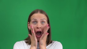 Beautiful girl in delight covers her face with her hands on a green background. Young woman overjoyed, isolated on green screen, chrome island. Woman smiling and screaming for success. - Powered by Shutterstock - Get 15% off with code: PIKWIZARD15
