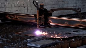 Plasma cutting of metal with a cnc. A plasma cutter cuts a workpiece from a sheet of metal. Laser cutter in production. Industrial metal cutting by plasma laser. 4K video. High definition video
