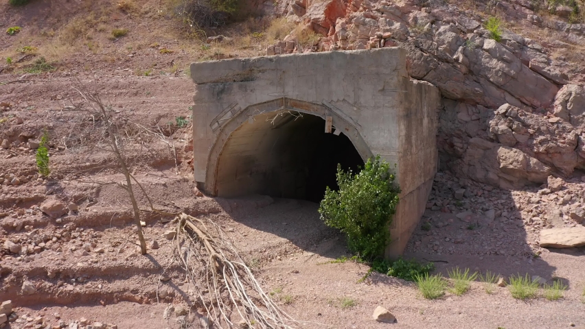 The span from the abandoned mine to the general view of the lake. The amazing nature of Kyrgyzstan. View from the height of the reservoir, rocky mountains, hills and quarry.
