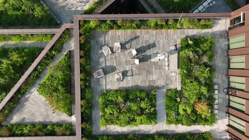 Rising aerial, outdoor living space. Green rooftop garden in urban city. Carbon emissions, climate change ESG theme, Royalty-Free Stock Footage #1094385481
