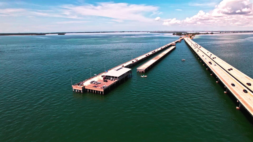 Cars Parked At The Sunshine Skyway Fishing Pier Next To Bob Graham Bridge In St. Petersburg, Florida. aerial
