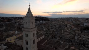 Aerial video of the church of Matera in Basilicata, southern Italy. Matera is listed as a UNESCO World Heritage Site, and the European Capital of Culture in 2019. Known for its ancient cave complex.