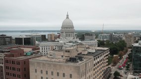 Wisconsin state capitol building in Madison, Wisconsin with drone video circling showing building roofs.