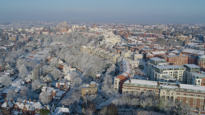 Cinematic aerial establishing shot of Nottingham England featuring snow covered houses during winter months