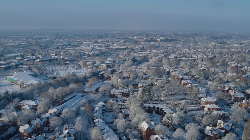 Wide aerial establishing shot of Nottingham england covered in a blanket of snow, housing market freeze concept shot