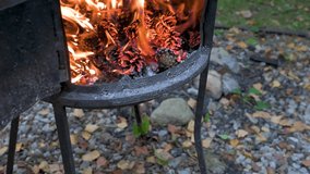 Fire place with red flame and pine cones. 4K video footage