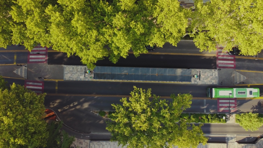 Bus Stop Aerial Shoot.Traffic in the city. Bus going in the bus line Royalty-Free Stock Footage #1094410095