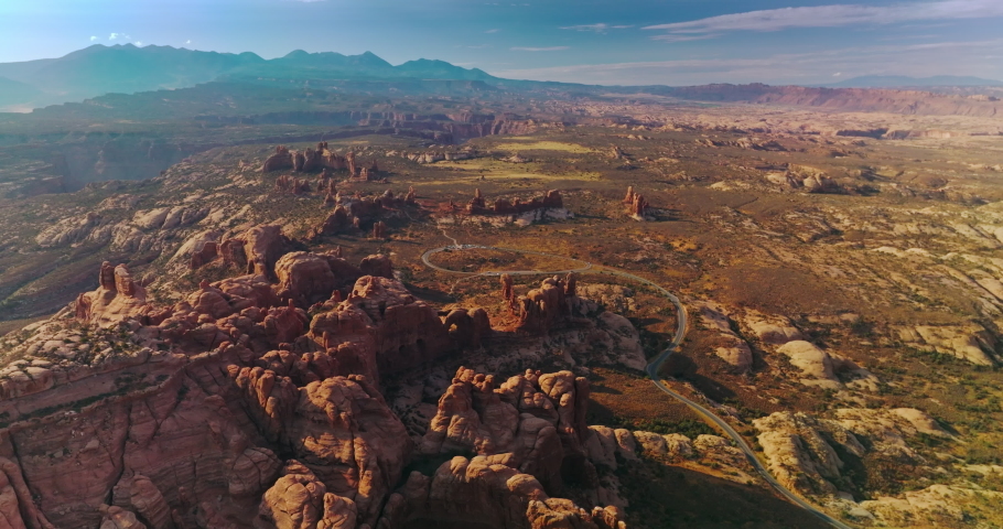 Uneven rocky landscape of amazing Utah State on wonderful sunny day. Fantastic blue sky over the canyons. Aerial view.
