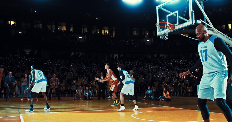 Basketball player throwing the ball into the hoop from a distance and scoring points. Opposite team player blocking. Players celebrating. 3d made basketball stadium with animated crowd. | Shutterstock HD Video #1094416371