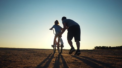Dad Teaches Daughter Ride Bike Happy Stock Footage Video (100% Royalty