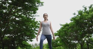 4K video Asian woman make yoga posture in park. Concept for healthy lifestyle and outdoor life.