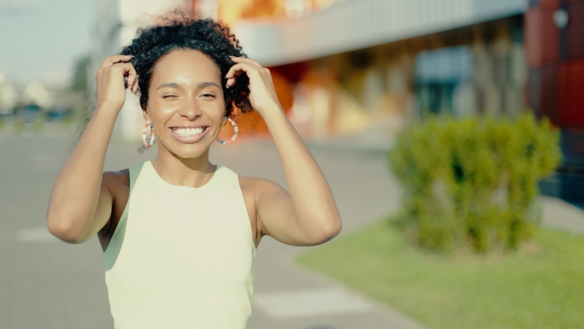 African-american young adult woman city portrait. Close up of woman's face at sunset. Urban style female. Modern buildings background. Royalty-Free Stock Footage #1094421821