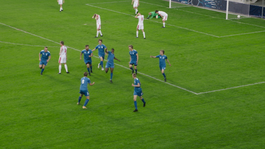 Soccer Football Championship: Blue Team Attack and Score Goal, Win the Match, Players Happy, Celebrate Victory, Winners of Tournament. Sport Channel Broadcast Television Playback. High Angle Wide