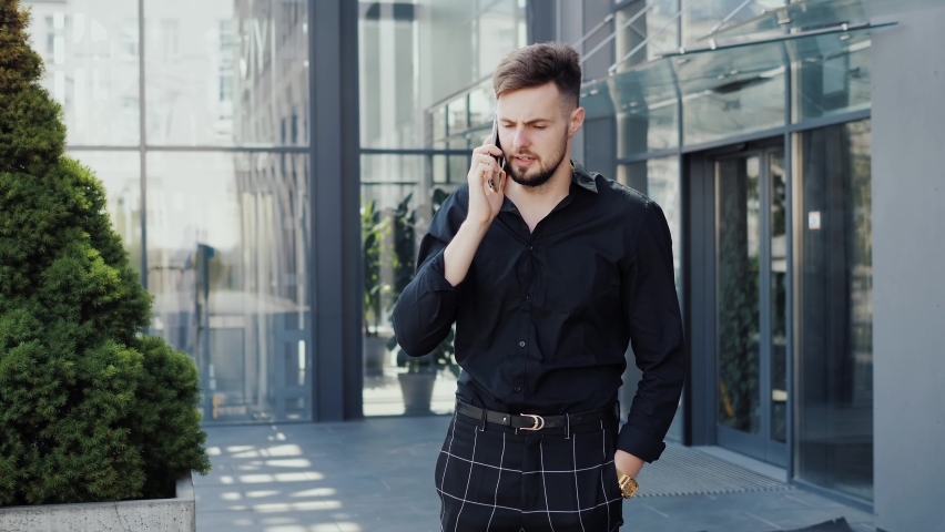 Portrait angry stressful businessman having mobile phone call, bad news talking on phone answering call worries about business job. Closeup excited man gesturing after calling outdoor. Shouting guy. | Shutterstock HD Video #1094425111