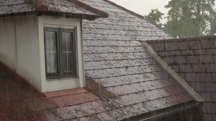 heavy rain flowing into roof gutter  Royalty-Free Stock Footage #1094431479