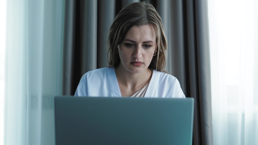 Portrait of Tired exhausted young woman surfing internet and social media on laptop, feeling bored and tireness, headache | Shutterstock HD Video #1094433993