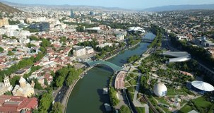 Aerial view of the city of Tbilisi, Georgia. Panoramic view of Rike Park, the Peace Bridge over the Kura River. Drone view of the city of Tbilisi.