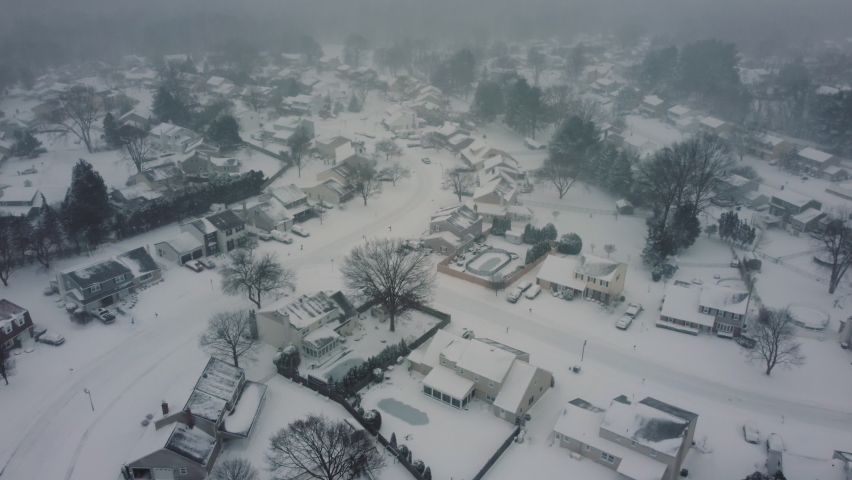 Aerial Drone of a suburban neighborhood during a snow storm.