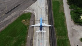 Aerial view following a airplane leaving a airport, on a cloudy day - tilt, drone shot - Powered by Shutterstock - Get 15% off with code: PIKWIZARD15