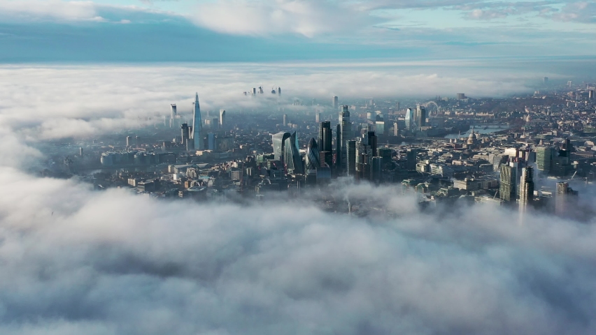Establishment Aerial view of London clouds and fog with Tower Bridge, sky garden, The Shard, Thames River, London Eye, The Gherkin, Cityscape and Iconic commercial Skyscrapers. United Kingdom Royalty-Free Stock Footage #1094441347