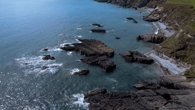 Atlantic Ocean waves and coastal rocks. Seaside landscape. Beautiful area near the coast of West Cork, Ireland. Aerial video in full hd format.