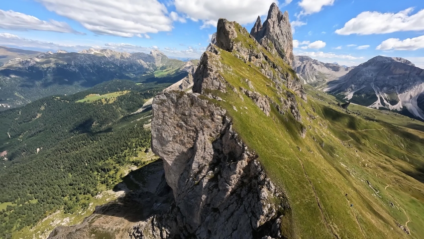 Seceda peak Italy. Dolomites Alps, South Tyrol in Italy, Europe. Odle mountain range, Val Gardena, Trentino Alto Adige. FPV fast race drone mountain surfing. Majestic Furchetta peak. Royalty-Free Stock Footage #1094450529