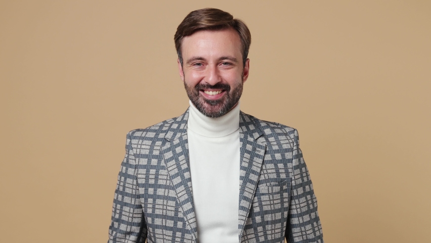 Young confident smiling fun successful employee business man corporate lawyer 30s wear classic formal grey suit jacket look aside camera work in office isolated on plain pastel light beige background | Shutterstock HD Video #1094455331