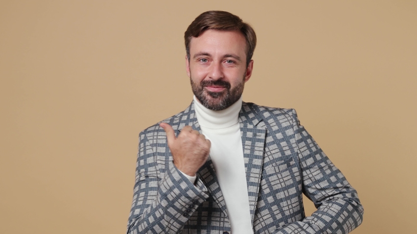Young fun employee business man corporate lawyer wear grey suit jacket dance clench fists waving gesticulating hands enjoy celebrate play work in office isolated on plain pastel light beige background | Shutterstock HD Video #1094455371